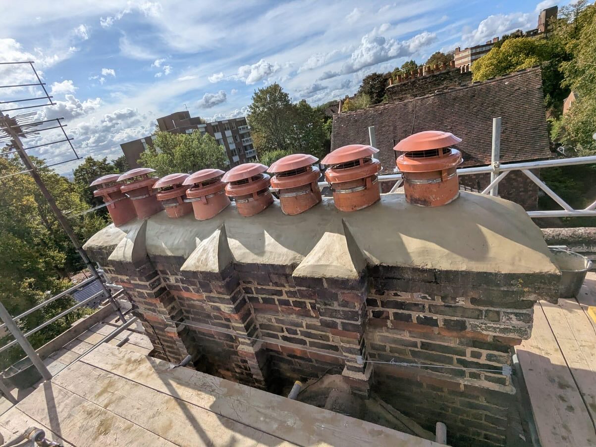 Re-flaunched chimney stack with terracotta pots and vented cowls on a house in Hornsey, North London