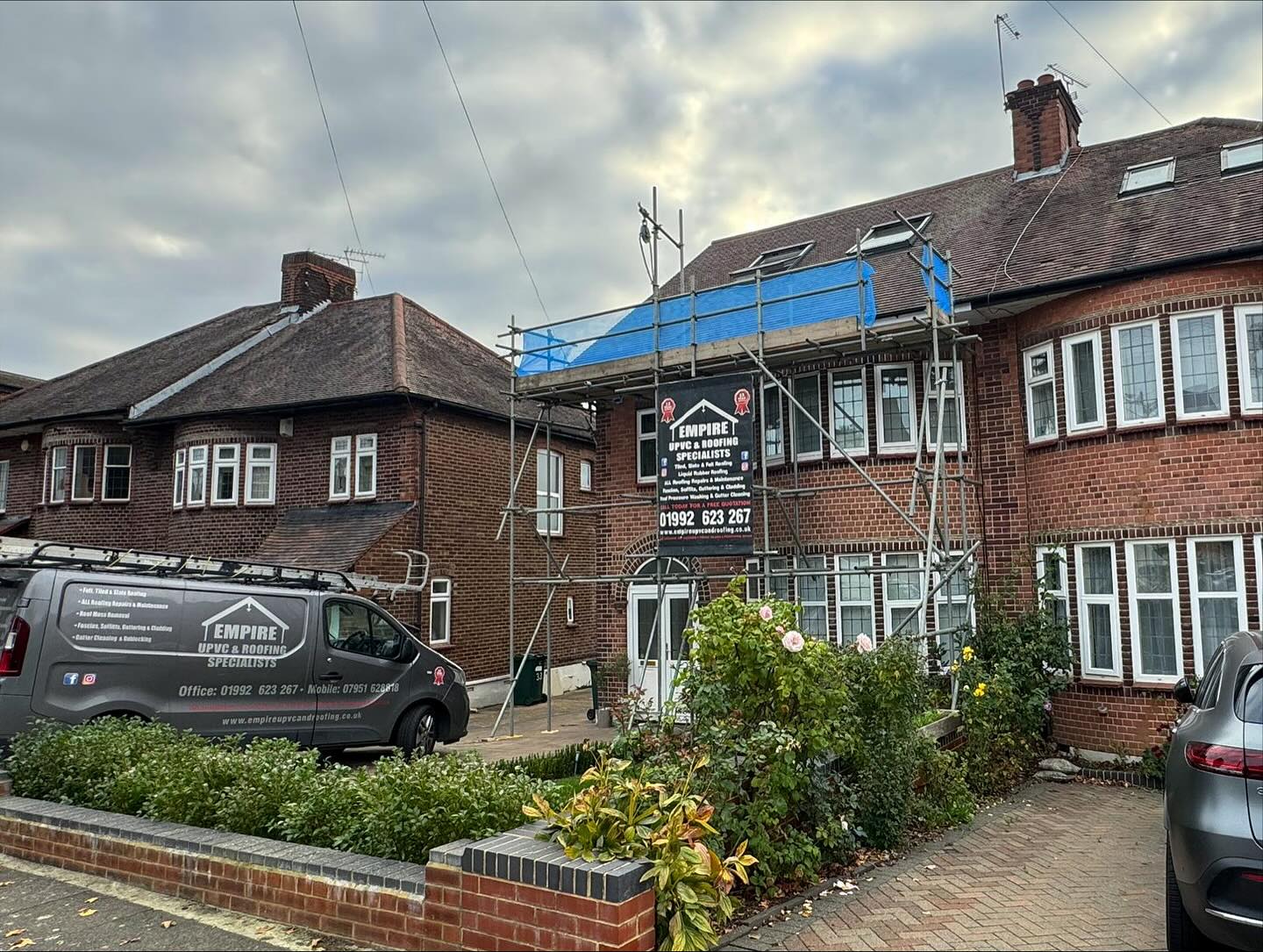 Scaffolding on a semi-detached house in Barnet for chimney cowl, roof vent and Velux flashing work